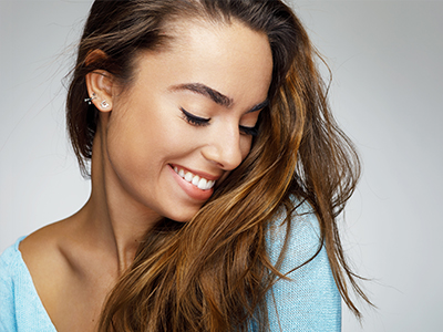 A woman with long hair smiling gently at the camera.